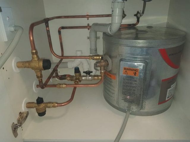 Repairs made to hot water cylinder under kitchen sink